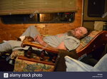 man-sleeping-in-a-recliner-with-his-dog-R0KE62.jpg