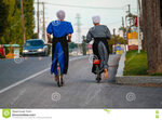 two-barefoot-amish-women-bikes-bird-hand-pa-september-riding-bicycles-main-road-lancaster-coun...jpg